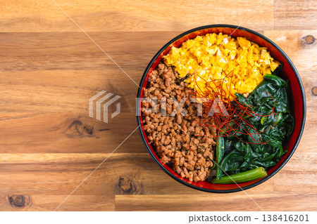 Three-color rice bowl: Japanese-style rice bowl with minced chicken, egg, and spinach. Three-color rice bowl: Japanese-style rice bowl with minced chicken, egg, and spinach. 138416201