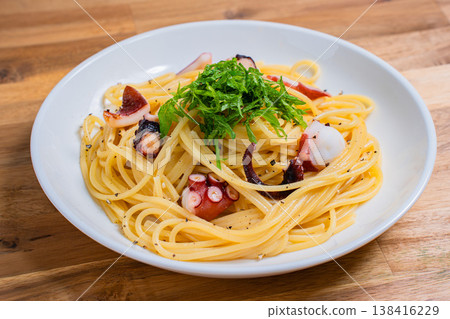 Japanese-style pasta with octopus and perilla leaves, spaghetti with simple seasoning. Japanese-style pasta with octopus and perilla leaves, spaghetti with simple seasoning. 138416229