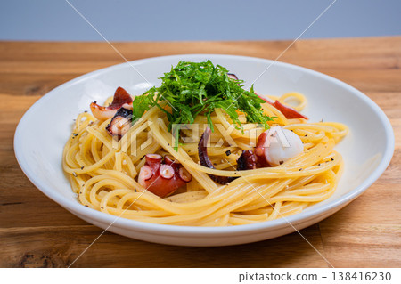 Japanese-style pasta with octopus and perilla leaves, spaghetti with simple seasoning. Japanese-style pasta with octopus and perilla leaves, spaghetti with simple seasoning. 138416230