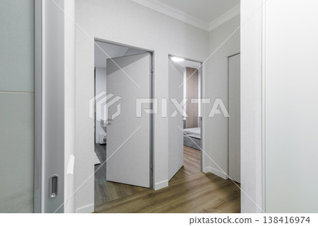 Modern Apartment Hallway with Multiple Grey Invisible Doors Modern Apartment Hallway with Multiple Grey Invisible Doors 138416974