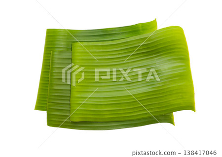 Stacked banana leaves on a white background, commonly used in traditional cooking. Stacked banana leaves on a white background, commonly used in traditional cooking. 138417046