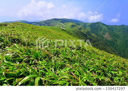 View of the southern side of the Izu mountain ridge trail from the summit of Mt. Daruma in summer on the Izu Peninsula. View of the southern side of the Izu mountain ridge trail from the summit of Mt. Daruma in summer on the Izu Peninsula. 138417297