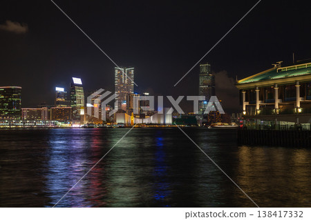 Vibrant night city skyline along a Hong Kong waterfront with colorful reflections 138417332