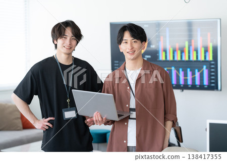 A young male engineer working on his office computer. 138417355
