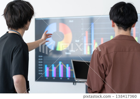 A young male engineer working on his office computer. 138417360