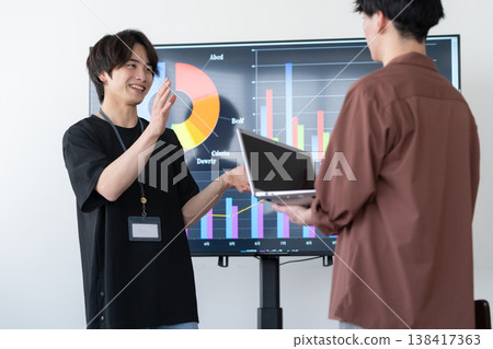 A young male engineer working on his office computer. A young male engineer working on his office computer. 138417363