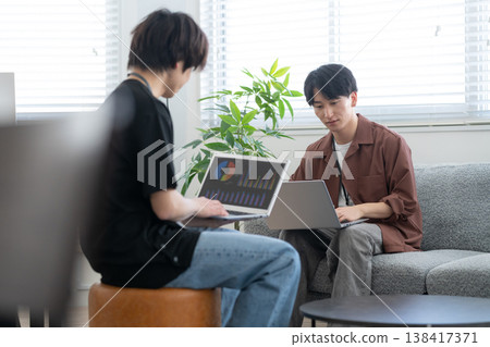 A young male engineer working on his office computer. A young male engineer working on his office computer. 138417371