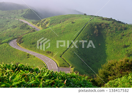 The Izu Ridge Trail on the Izu Peninsula: A view of the ridge trail leading to the grasslands from Mt. Daruma, as well as Mt. Koki and the West Izu Skyline. The Izu Ridge Trail on the Izu Peninsula: A view of the ridge trail leading to the grasslands from Mt. Daruma, as well as Mt. Koki and the West Izu Skyline. 138417582