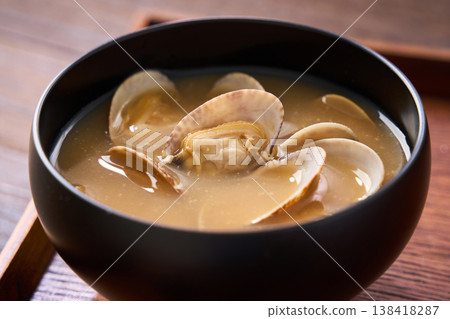 Clam miso soup, a Japanese soup served in a black bowl. Clam miso soup, a Japanese soup served in a black bowl. 138418287