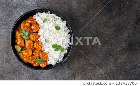 Indian chicken butter masala curry with basmati rice on a gray background. Top view. Copy space. Banner. Indian food. Indian chicken butter masala curry with basmati rice on a gray background. Top view. Copy space. Banner. Indian food. 138418700