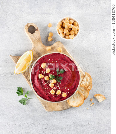 Beetroot hummus with parsley and olive oil in plate on a gray background, top view. Copy space. Arabic, Turkish cuisine. 138418766