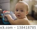 Caucasian Infant Exploring Toy Keyboard On Floor, Hands On Keys, Inquisitive Expression, Soft Natural Window Light, Early Music Play And Sensory Discovery Scene 138418785