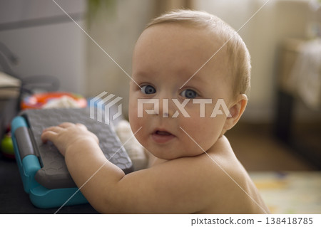 Caucasian Infant Exploring Toy Keyboard On Floor, Hands On Keys, Inquisitive Expression, Soft Natural Window Light, Early Music Play And Sensory Discovery Scene Caucasian Infant Exploring Toy Keyboard On Floor, Hands On Keys, Inquisitive Expression, Soft Natural Window Light, Early Music Play And Sensory Discovery Scene 138418785