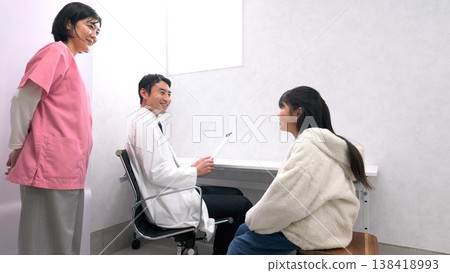 Image of an elementary school student telling his teacher about his symptoms Image of an elementary school student telling his teacher about his symptoms 138418993