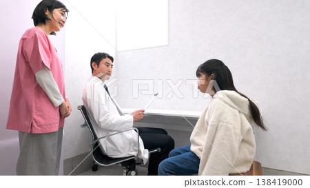 Image of an elementary school student telling his teacher about his symptoms Image of an elementary school student telling his teacher about his symptoms 138419000