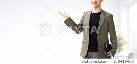 A male businessman giving directions with his palm. 138419438