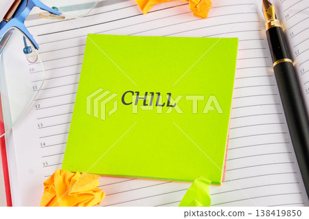 A vivid green note with CHILL rests on an open schedule book, beside sleek glasses and a golden nib pen, inspiring a tranquil pause from daily tasks A vivid green note with CHILL rests on an open schedule book, beside sleek glasses and a golden nib pen, inspiring a tranquil pause from daily tasks 138419850