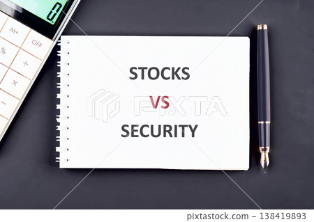 Fundamental investment terms, stocks and security, are contrasted on a crisp white notepad, surrounded by essential accounting instruments on a dark surface Fundamental investment terms, stocks and security, are contrasted on a crisp white notepad, surrounded by essential accounting instruments on a dark surface 138419893