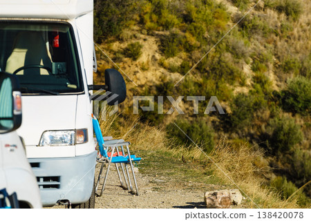 Rv motorhome with two chairs ready for outdoor living. Camping on nature Rv motorhome with two chairs ready for outdoor living. Camping on nature 138420078