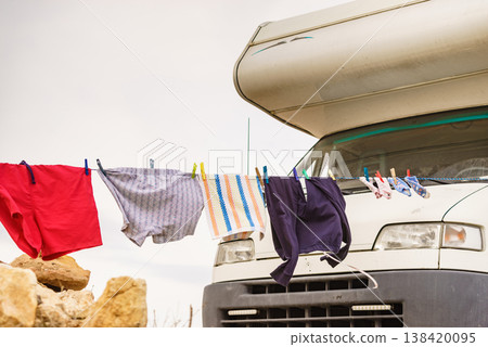Washing laundry hanging to dry outdoors at caravan. Camping on nature, lifestyle. Washing laundry hanging to dry outdoors at caravan. Camping on nature, lifestyle. 138420095