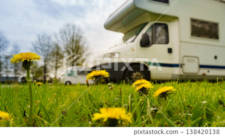 Spring green meadow with flowers and caravan camping in the distance Spring green meadow with flowers and caravan camping in the distance 138420138