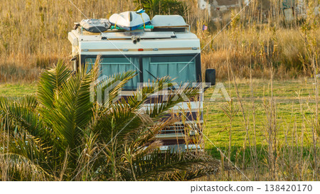 Campar with camping gear packed on vehicle roof rack ready for adventure in nature. 138420170