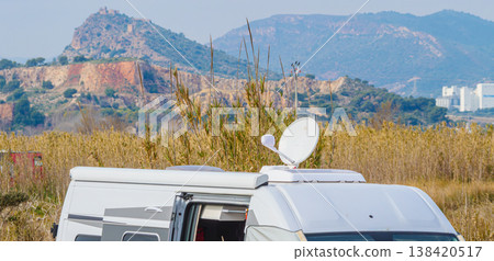 Caravan with satellite dish on roof camping on spanish nature 138420517