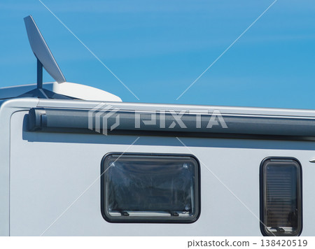 Awning on side of caravan and Starlink terminal on roof Awning on side of caravan and Starlink terminal on roof 138420519