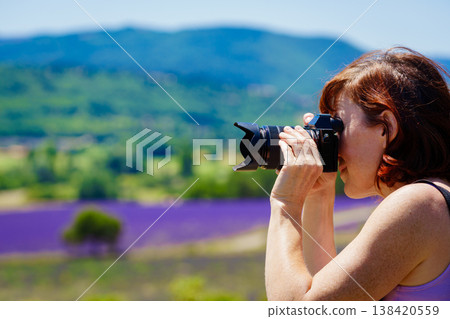Tourist woman take photo on lavender field, Vaucluse department in Provence France 138420559
