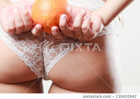 Girl holding orange in front of bottom 138420842