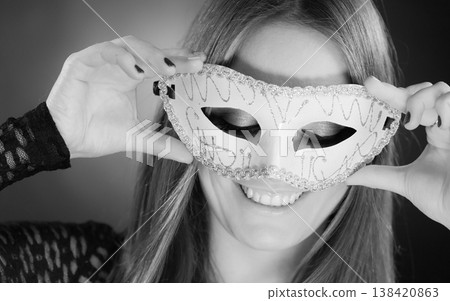Woman holding carnival mask closeup Woman holding carnival mask closeup 138420863