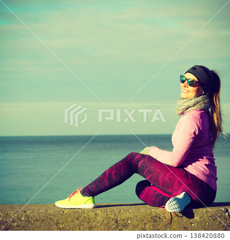 Woman resting after doing sports outdoors on cold day Woman resting after doing sports outdoors on cold day 138420880