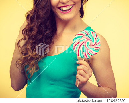 Woman charming girl with lollipop candy Woman charming girl with lollipop candy 138420891