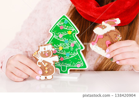 Woman santa claus hat with gingerbread cookies. Christmas 138420904