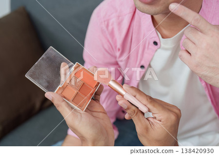 Diverse beauty: Men exploring makeup artistry with a palette and brush Diverse beauty: Men exploring makeup artistry with a palette and brush 138420930
