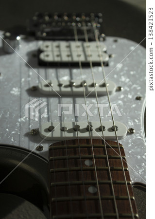 This is a close-up of the electric guitar strings. 138421523