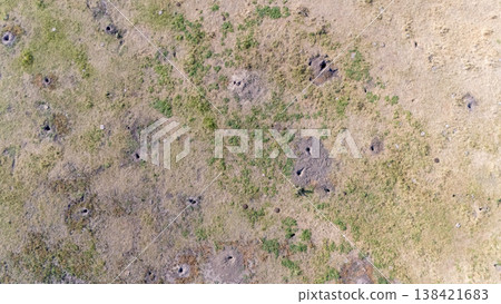 aerial view looking down over a vast field of Prairie dog burrows and tunnel openings 138421683