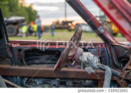 Selective focus on the interior steering column and wheel on a modified car for a demolition derby 138421691