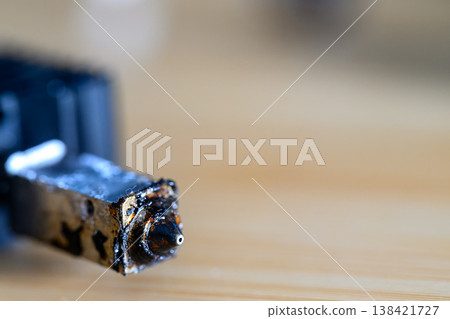 Selective focus on charred and plugged hot end extruder of a 3D filament printer Selective focus on charred and plugged hot end extruder of a 3D filament printer 138421727