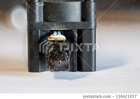 Selective focus on charred and plugged hot end extruder of a 3D filament printer Selective focus on charred and plugged hot end extruder of a 3D filament printer 138421857