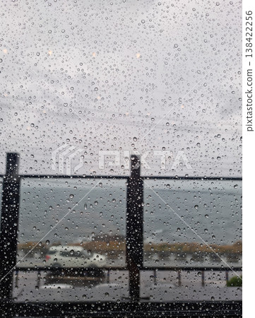 Raindrops forming on the window on a rainy day. 138422256