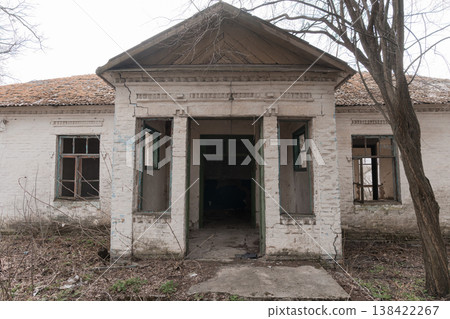 Abandoned White Brick Schoolhouse With Green Trim And Broken Windows Showing Decay In Overgrown Yard During Early Spring Season Abandoned White Brick Schoolhouse With Green Trim And Broken Windows Showing Decay In Overgrown Yard During Early Spring Season 138422267