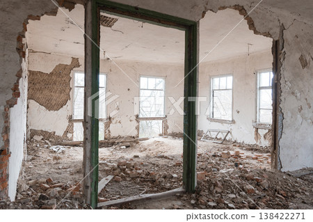 Abandoned Dilapidated Room With Crumbling Walls, Scattered Bricks, Green Door Frame, and Broken Windows Showing Decay Texture Abandoned Dilapidated Room With Crumbling Walls, Scattered Bricks, Green Door Frame, and Broken Windows Showing Decay Texture 138422271