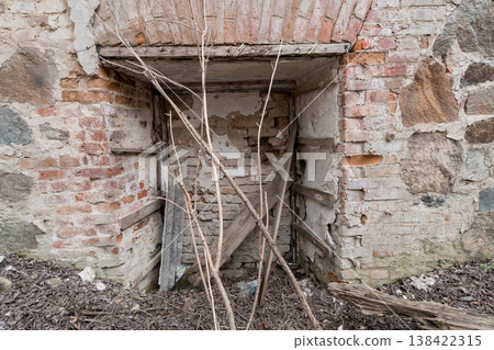 Dilapidated Brick Archway Entrance With Weathered Wooden Supports And Dry Twigs In Abandoned Rural Building Exterior Scene Dilapidated Brick Archway Entrance With Weathered Wooden Supports And Dry Twigs In Abandoned Rural Building Exterior Scene 138422315