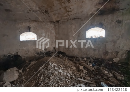 Dilapidated Stone Room With Arched Windows And Debris Pile Showing Weathered Walls, Rough Textures, Gray Tones, Abandoned Interior Scene Dilapidated Stone Room With Arched Windows And Debris Pile Showing Weathered Walls, Rough Textures, Gray Tones, Abandoned Interior Scene 138422318