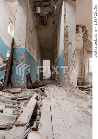 Abandoned Blue-Walled Corridor With Crumbling Walls And Debris-Littered Floor Showing Decay In Dilapidated Building Interior Abandoned Blue-Walled Corridor With Crumbling Walls And Debris-Littered Floor Showing Decay In Dilapidated Building Interior 138422355