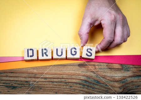 DRUGS Illegal Trade And Social Risk Concept With Wooden Letter Blocks 138422526