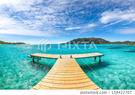 Breathtaking landscape with wooden pier on Santa Giulia beach. Breathtaking landscape with wooden pier on Santa Giulia beach. 138422707