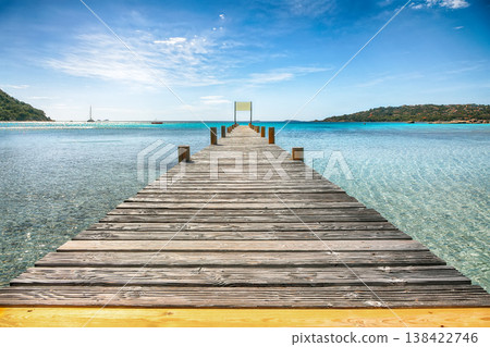 Breathtaking landscape with wooden pier on Santa Giulia beach. Breathtaking landscape with wooden pier on Santa Giulia beach. 138422746