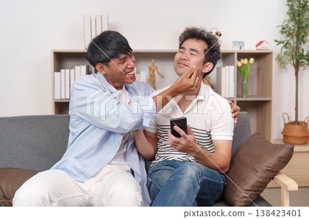 LGBTQ couple sharing a playful moment at home LGBTQ couple sharing a playful moment at home 138423401